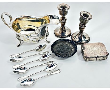 A silver collection to include a late Victorian scrolled pin tray, a pair of candlesticks, a gravy boat, cased set of six tea