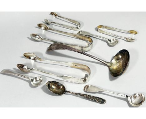 A selection of silver flatware, ladle, sugar tongs, a silver babies bangle, 999. silver ingot, and dressing table ware etc 10