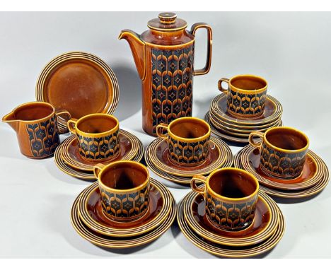 A collection of Hornsey Airloom pattern tableware including cups and saucers and a number of lidded storage jars 