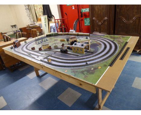 An OO Gauge Train Layout with Trains, Buildings and Accessories to Include Flying Scotsman and Tender, Two Tank Locomotives, 