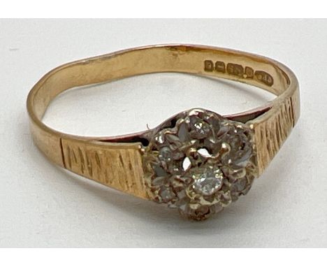 A large vintage 9ct gold illusion set diamond cluster dress ring. Central round cut diamond surrounded by 6 small round cut d