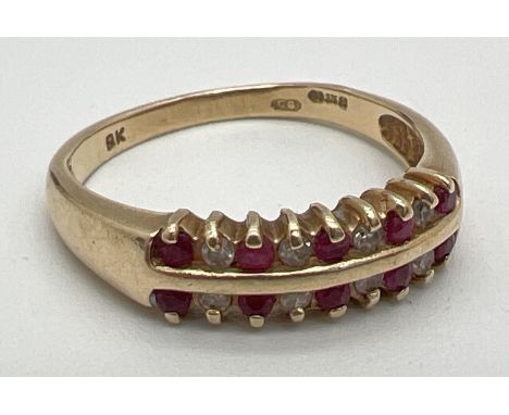 A 9ct gold ruby and diamond double row half eternity ring. 2 rows of alternating rubies and diamonds. Full hallmarks to insid