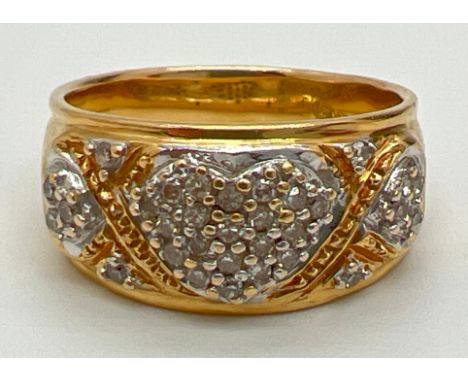 An 18ct gold and diamond set band ring. 3 heart shapes to front of band each set with small round cut diamonds. Diamonds tota