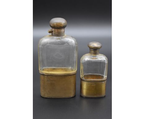 A small silver gilt mounted glass hip flask, by N M, London 1911, 11cm; together with a larger silver mounted example, by&nbs