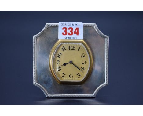 A vintage white metal desk clock, having Swiss manual winding movement, 9.5cm. 