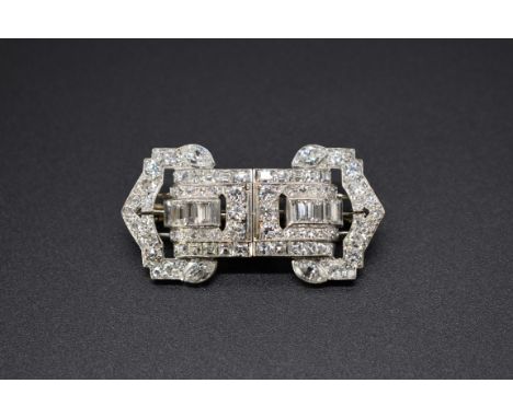 An Art Deco diamond set double clip brooch, set baguette, old cut, step cut and marquise diamonds, 4.5cm. 