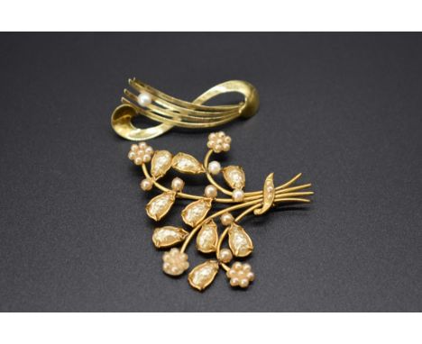 A yellow metal brooch set, with a seed pearl, stamped&nbsp;585, 4.5cm; together with a floral costume brooch. 