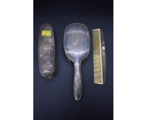 Two continental .925 sterling hair brushes, by J B; and a similar white metal comb. 