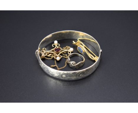 A silver hinged bangle; together with a ring stamped .925; a gilt pendant necklace, set garnet and pearls, stamped 925; and a