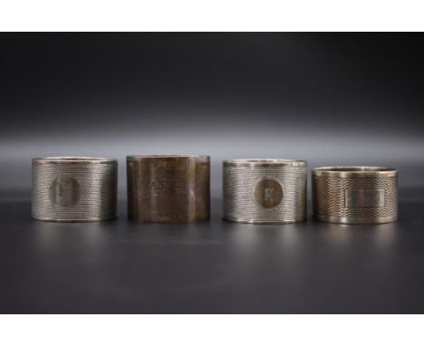 A pair of engine turned silver napkin rings, by Viners, Sheffield 1935; together with two other silver napkin rings, 160g. 