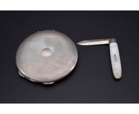 An engine turned silver compact, by&nbsp;Cohen &amp; Charles, London 1936, 7.5cm diameter; together with a silver and mother-