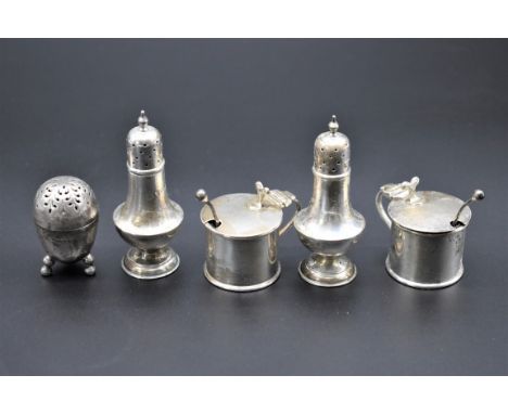 A pair of Edwardian silver drum mustards, by Haseler Brothers, Chester 1904, 3cm high; together with two pepperettes by the s
