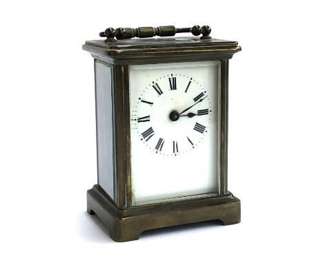 A late 19th/early 20th century brass carriage clock with enamel dial painted with Roman numerals, 10.6cmH, backplate engraved