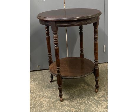 A late Victorian circular rosewood lamp table, on turned legs and undershelf, 53x70cm