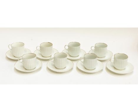 A set of eight teacups and saucers in ribbed form, heightened in gilt, blue underglaze cross sword 'S' mark to base for Schle
