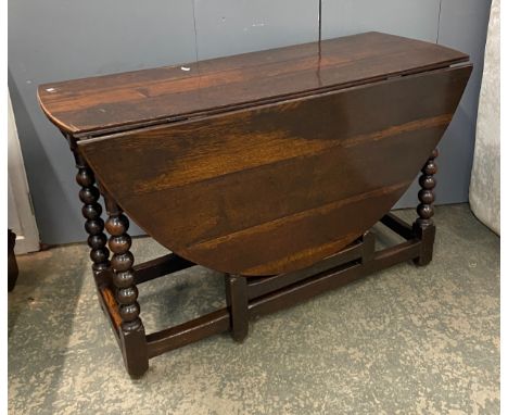 A late 17th century oak oval gate leg table on bobbin turned supports joined by peripheral stretches, 116cmx47cmx73cm, 147cm 