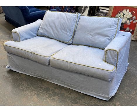A good quality William Yeoward sofa bed, upholstered in a pale blue linen style fabric with gold piping, 180cmW