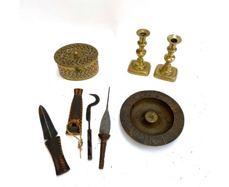 A mixed lot of metal items to include; tools with carved handles, tribal blade with carved wood handle and scabbard, two bras