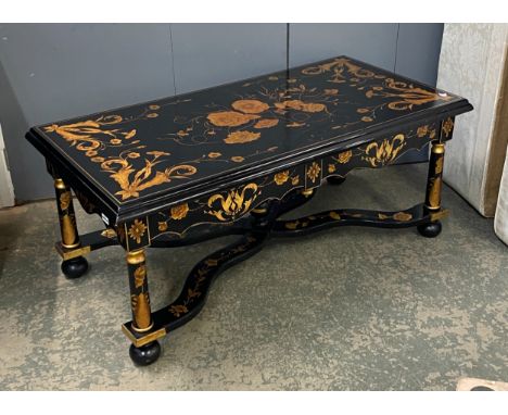 An ebonised and gilt coffee table, 20th century, decorated with floral motifs, two drawers, on turned supports, joined by sha