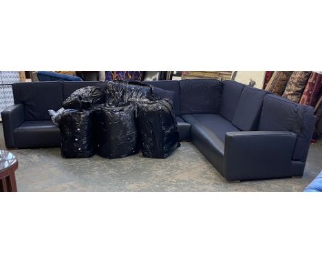 A very large black leather and fabric upholstered contemporary corner sofa