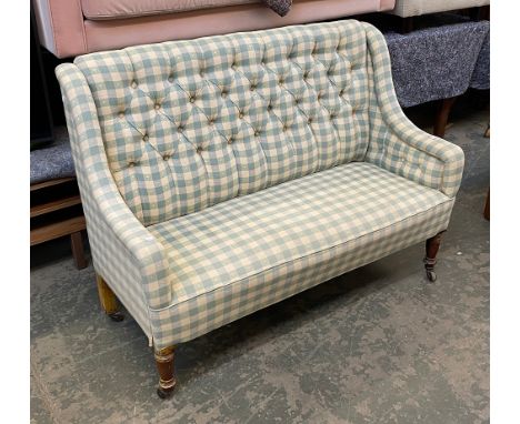 A button back two seater sofa, on turned front legs and ceramic casters, 137cmW