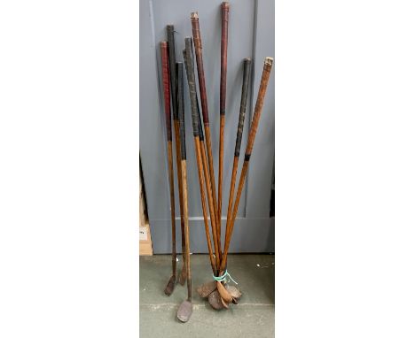 A quantity of vintage golf irons, drivers, and putters, to include a WM Gibson &amp; Co Army &amp; Navy 'Holdfast' putter, ma