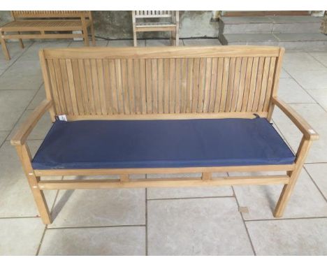 A teak hardwood bench with a blue cushion 150cm wide 