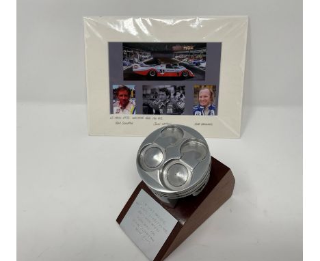 Plinth-mounted used piston from a Weslake-Ford V12 fitted to a 1973 Gulf Mirage M6.Piston from a 1973 Le Mans-prepared Gulf M