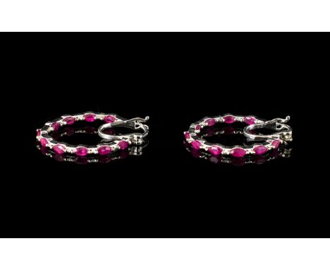 Ruby Hoop Earrings, a pair of fine hoops set with marquise cut rubies to both the front and inside back curves of the circles