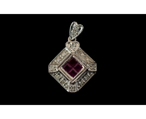 9ct White Gold Ruby And Diamond Set Designer Style Pendant Set with four calibre cut rubies surrounded by round cut diamond a