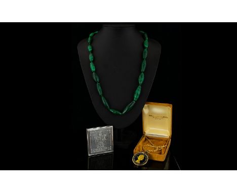 Early 20th Century Malachite Bead Necklace Comprising graduating capsule form malachite beads of good colour and striation se