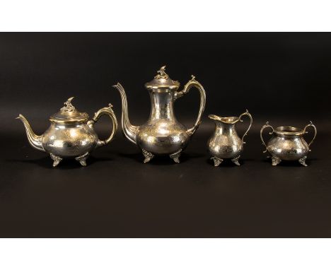 A Four Piece Anglo Indian Style Plated Metal Tea And Coffee Service Comprising footed teapot, twin handle sugar bowl,tall cof