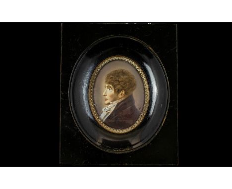 A 19th Century Portrait Miniature Housed in black lacquered frame, depicting an profile portrait of male aristocrat in velvet