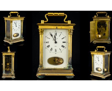A Brass Cased Carriage Clock Comprising white enamel dial, Roman numerals with outer minutes track, visible pendulum. Height 