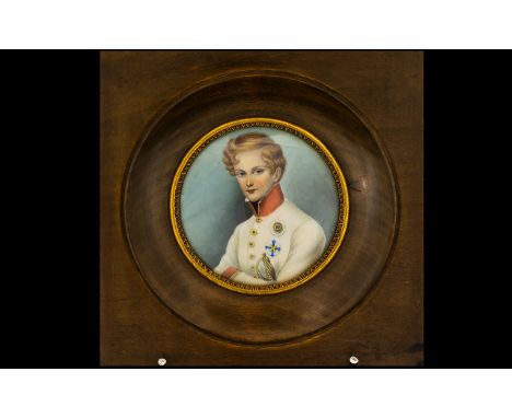 A 19th Century Circular Portrait Miniature Housed in glazed walnut frame, depicting a young man in military uniform. Signed t