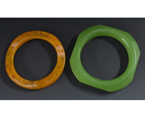 A Christian Dior Germany plastic bracelet in jade tones; another in amber tones