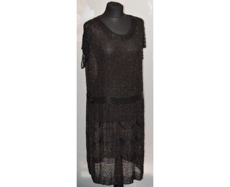 A 1920s Art Deco flapper style dress, black with beaded detail 