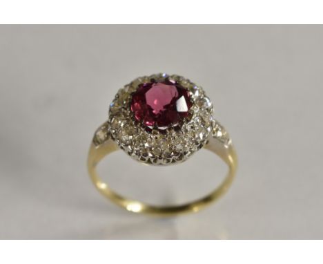 A spinel and diamond cluster ring, central rose pink spinel approx 1.77ct, surrounded by a band of fourteen round cut diamond