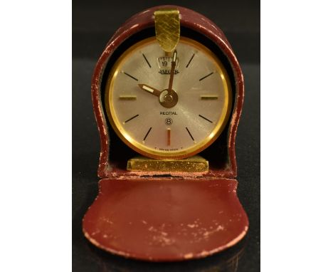 A Jaeger Recital 8 day travelling alarm clock, gilt metal case, textured effect, baton numerals, cased 