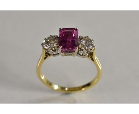 A sapphire and diamond trilogy ring, central octagonal cut pink sapphire, measuring 8.23mm x 5.46mm x 4.24mm, stone eight 2.1