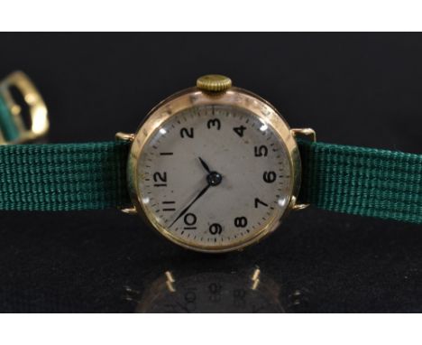Omega - a lady's vintage 1920s 9ct gold cased wristwatch, textured silvered dial, Arabic numerals, minute track, blued hands,