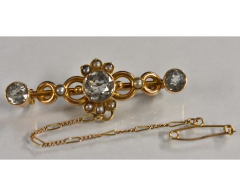 A Victorian aquamarine and seed pearl brooch, central round pale blue aquamarine within a cresting seed pearl and ring frame,