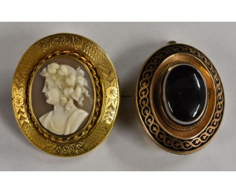 A Victorian carved shell cameo portrait mourning brooch, possibly Aphrodite, within a textured chased yellow metal glazed bac