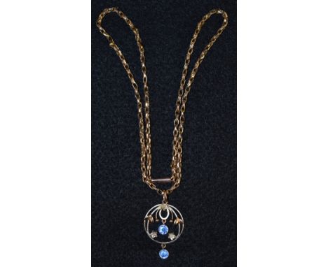 An Edwardian Art Nouveau seed peral and paste pendant necklace, circular sinuous body inset with three seed pearls and two bl