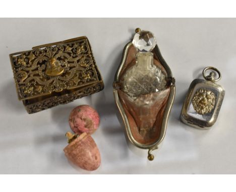 A miniature jointed doll inside an egg; a miniature scent bottle; a pierced stamp case; a seal (4) 