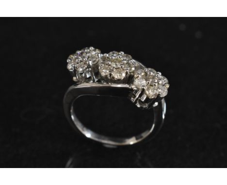 A diamond triple head cluster ring, each floral head inset with seven round brilliant cut diamonds, total estimated diamond w