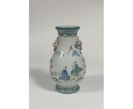A modern Chinese famille verte style baluster vase decorated with three figures in a garden and elephant head twin ring handl