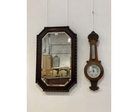 A 1930's oak wall hanging mirror with beeded moulding and bevelled edge (84cm x 54cm) together with a late Victorian aneroid 