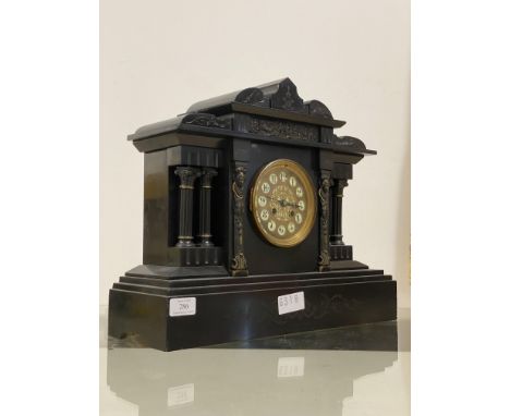 A Victorian slate mantel clock of architetchural form, inset with cast metal frieze depicting Greco-Roman imagery, white ivor