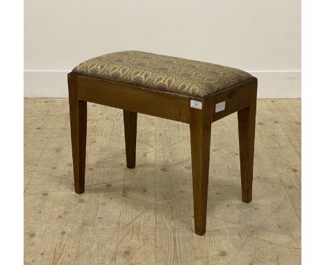 An Edwardian mahogany piano stool, the drop in seat pad upholstered in a floral embroidered fabric, raised on square tapered 